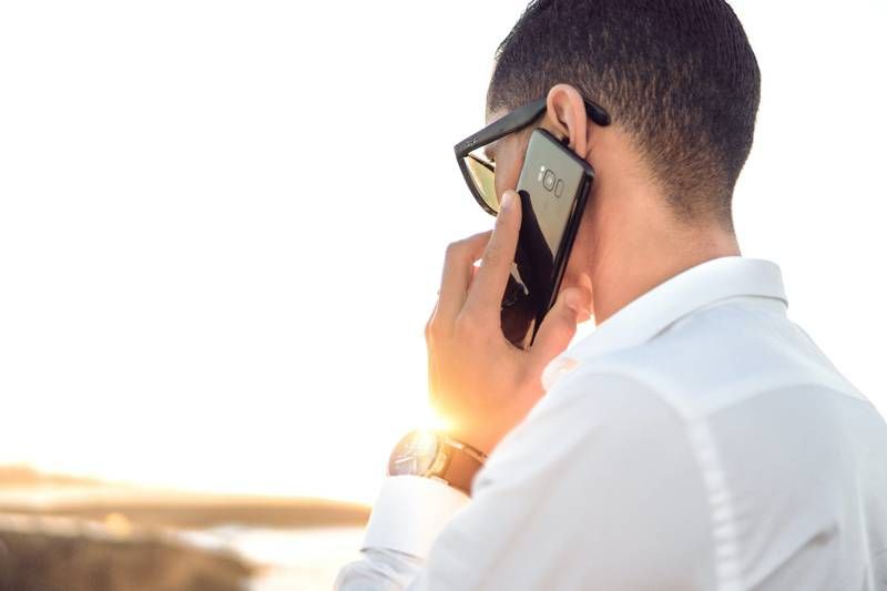 boy with his back to cell phone